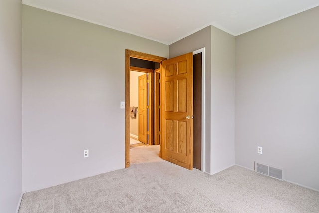 unfurnished room with light colored carpet