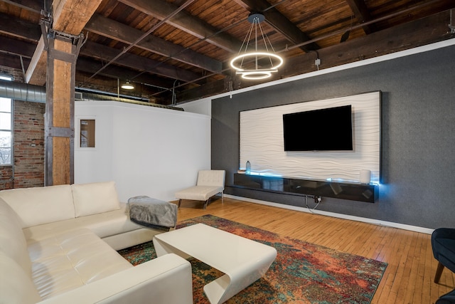 living room featuring beamed ceiling, wood ceiling, brick wall, and hardwood / wood-style flooring