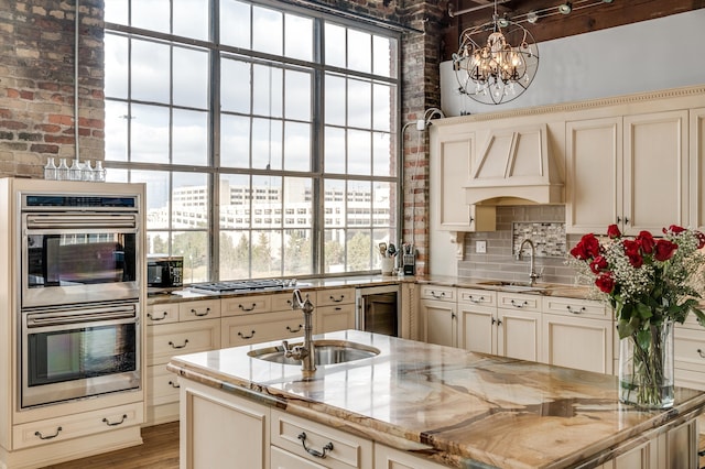 kitchen featuring sink, stainless steel appliances, and cream cabinetry