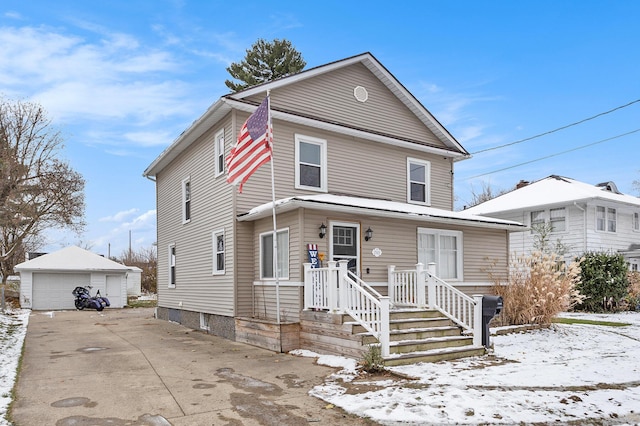 front facade featuring a garage and an outbuilding