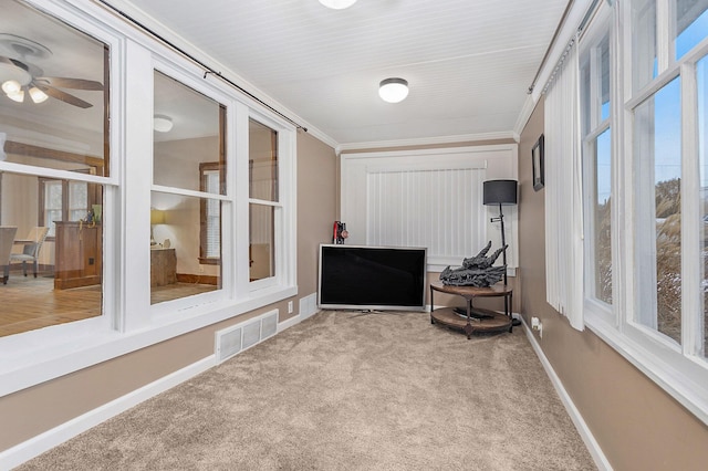 sunroom / solarium featuring plenty of natural light and ceiling fan