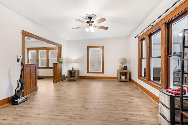 unfurnished living room featuring ceiling fan and light wood-type flooring