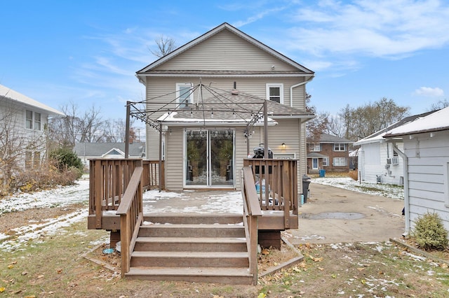 back of house featuring a wooden deck