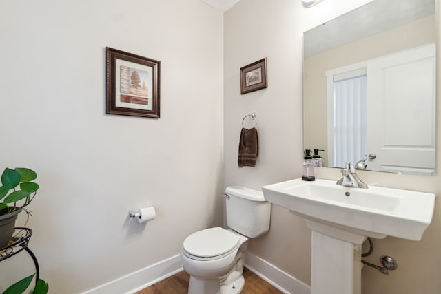 bathroom featuring toilet and hardwood / wood-style flooring