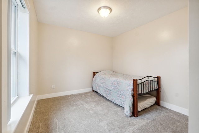 bedroom featuring light carpet