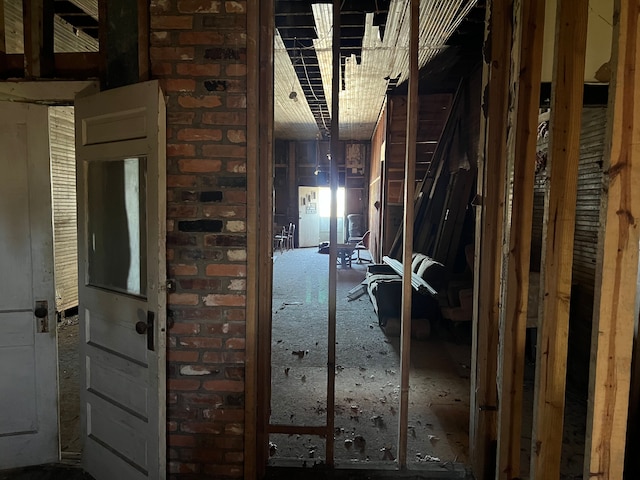 interior space featuring brick wall