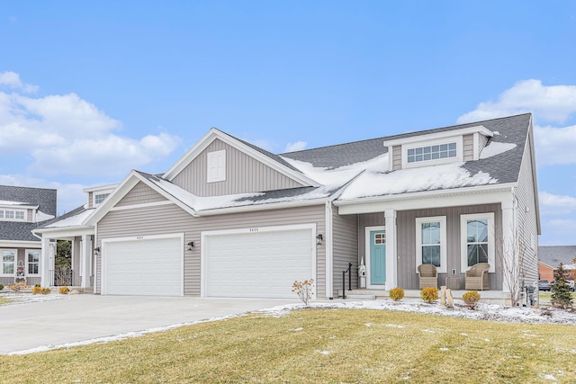 view of front of home with a front yard and a garage