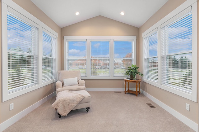 sitting room with lofted ceiling and light colored carpet