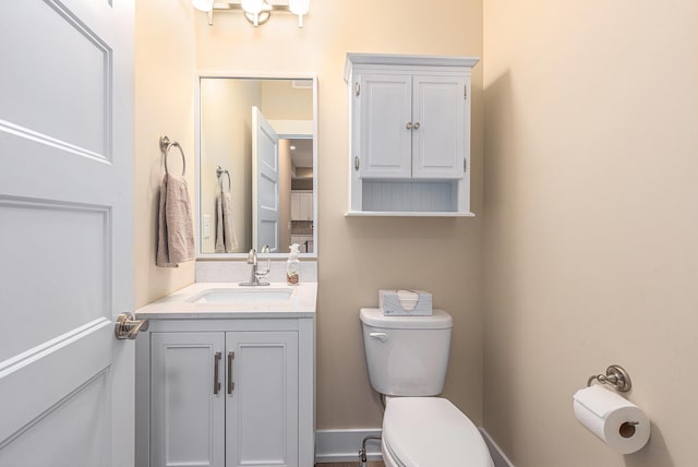 bathroom with toilet and vanity