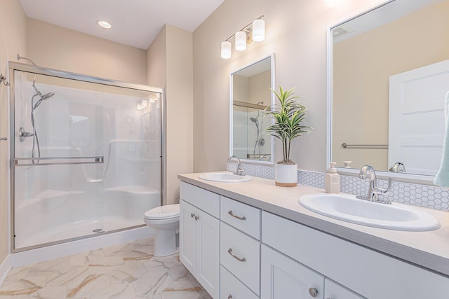 bathroom featuring an enclosed shower, vanity, and toilet