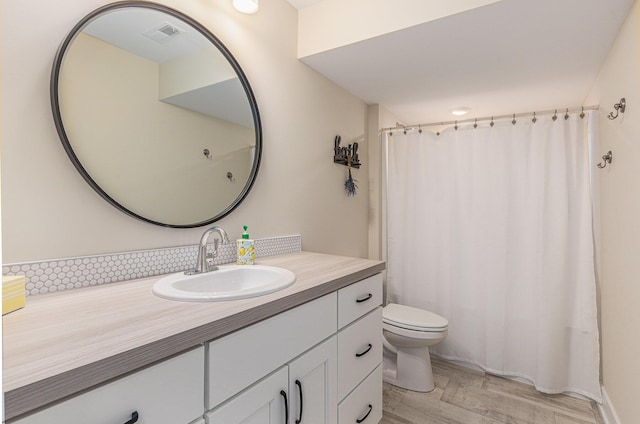 bathroom featuring hardwood / wood-style floors, toilet, and vanity