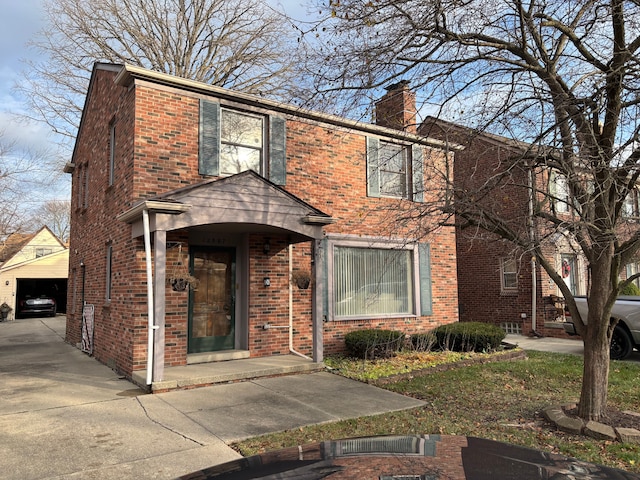 view of front facade featuring a garage and an outdoor structure