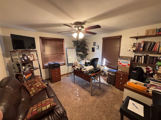 carpeted office featuring ceiling fan