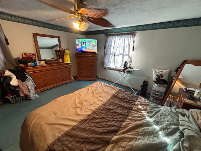 carpeted bedroom with ceiling fan and a textured ceiling