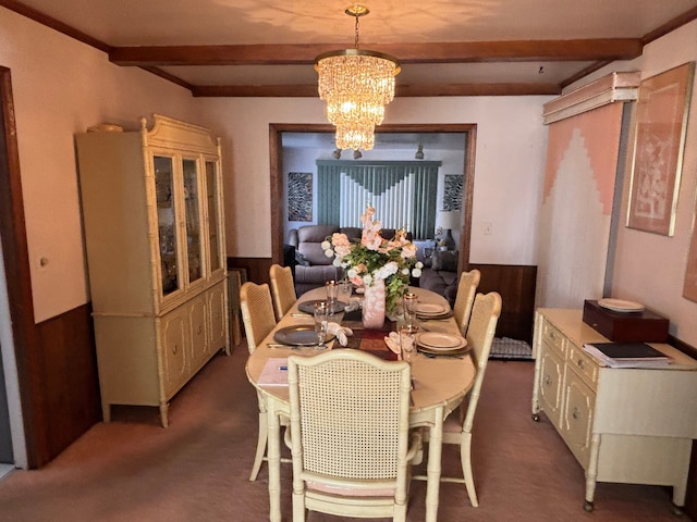 dining space featuring carpet flooring, beam ceiling, and a chandelier