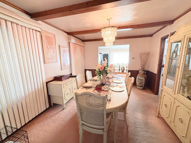 carpeted dining room with a notable chandelier and beam ceiling