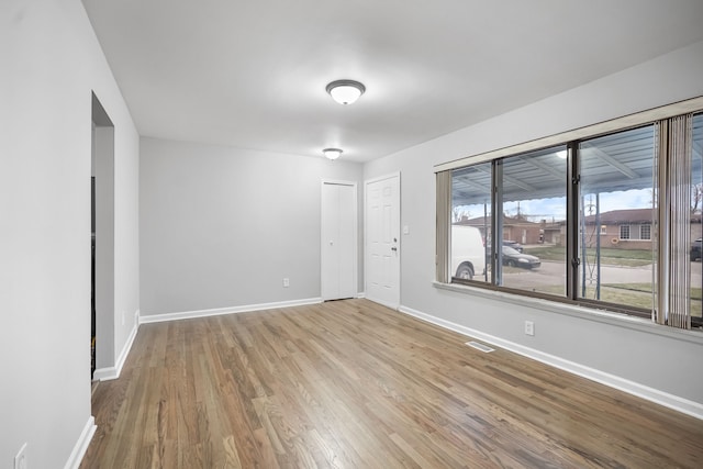 empty room with light hardwood / wood-style floors