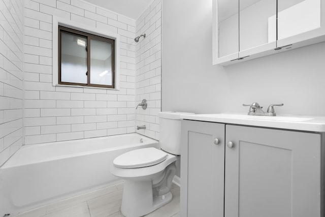 full bathroom featuring vanity, tiled shower / bath combo, and toilet