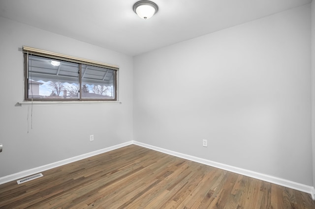 unfurnished room with wood-type flooring