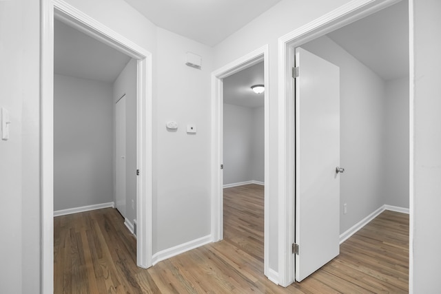 hallway with hardwood / wood-style floors