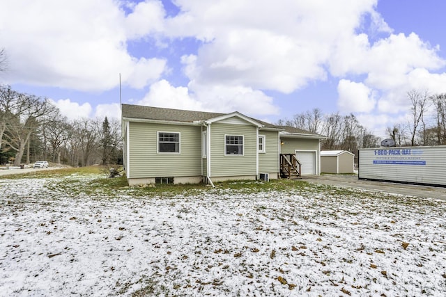 snow covered property featuring a garage