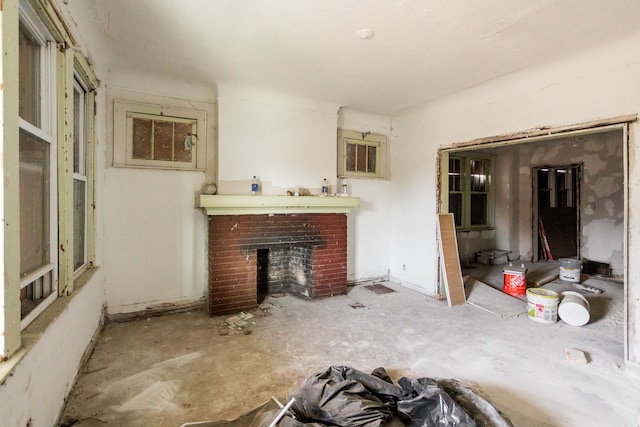 living room featuring a brick fireplace