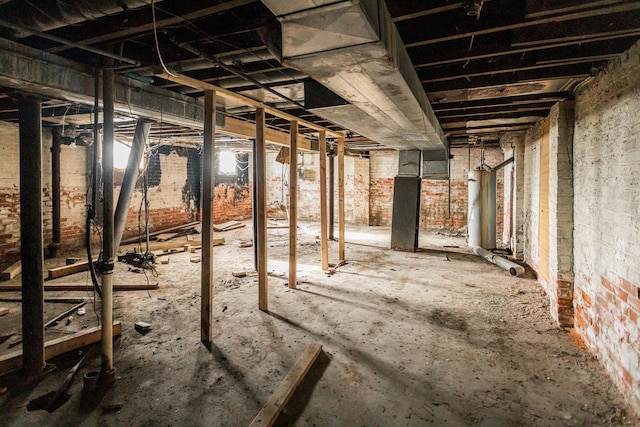 basement with brick wall