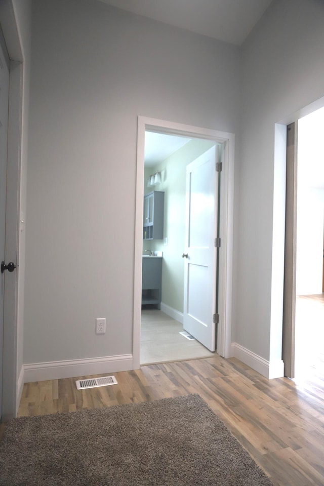 unfurnished room with visible vents, baseboards, and wood finished floors