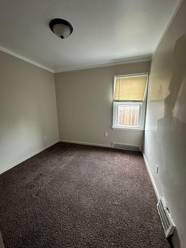 carpeted empty room featuring ornamental molding