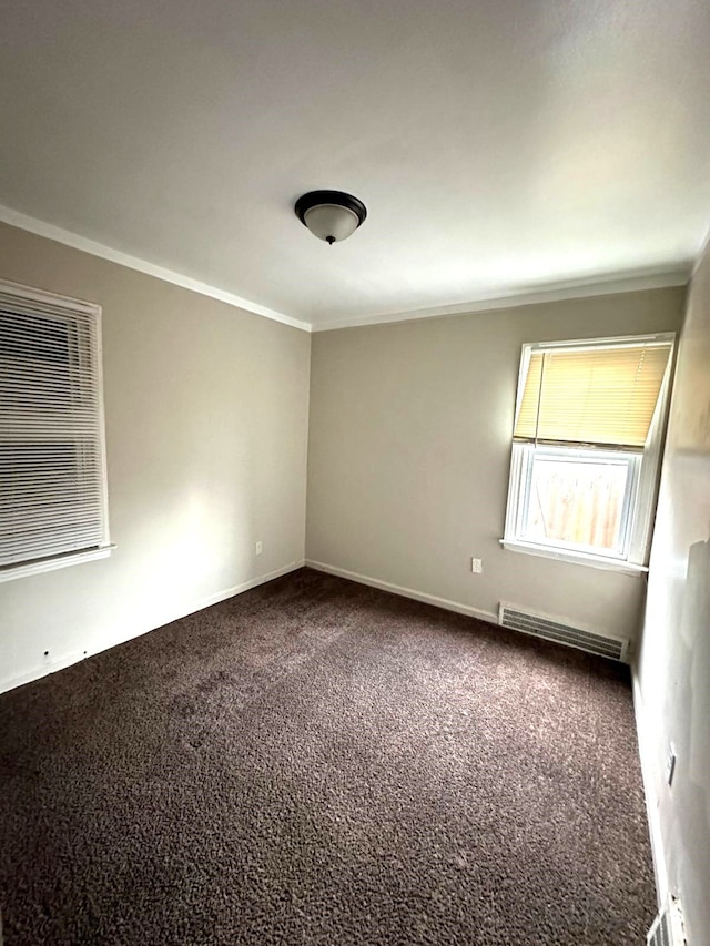 unfurnished room with carpet and crown molding