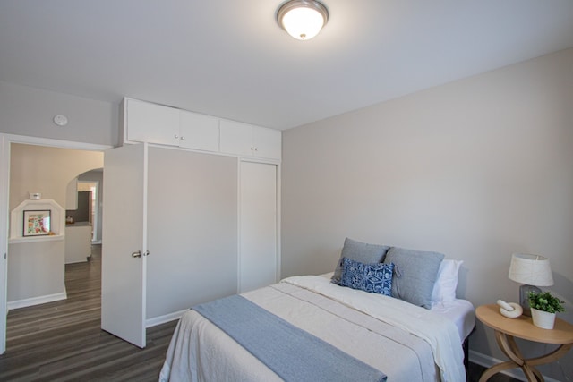 bedroom featuring dark hardwood / wood-style flooring and a closet