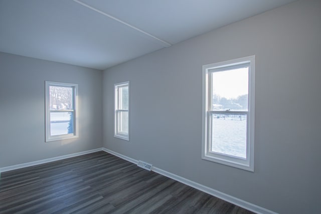 spare room with dark hardwood / wood-style flooring