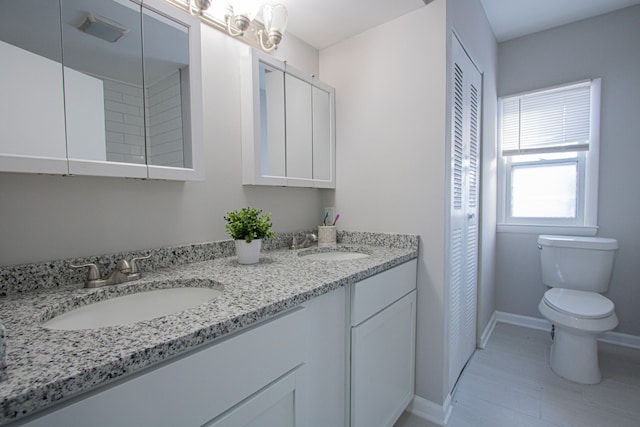 bathroom featuring tile patterned floors, vanity, and toilet