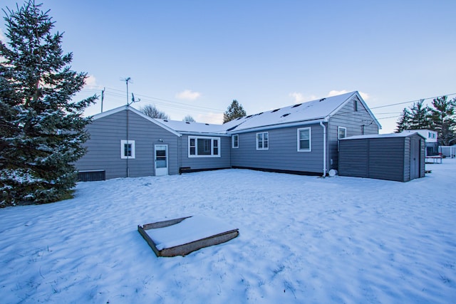 snow covered property with an outdoor structure