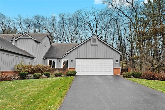 view of front facade with a front yard and a garage