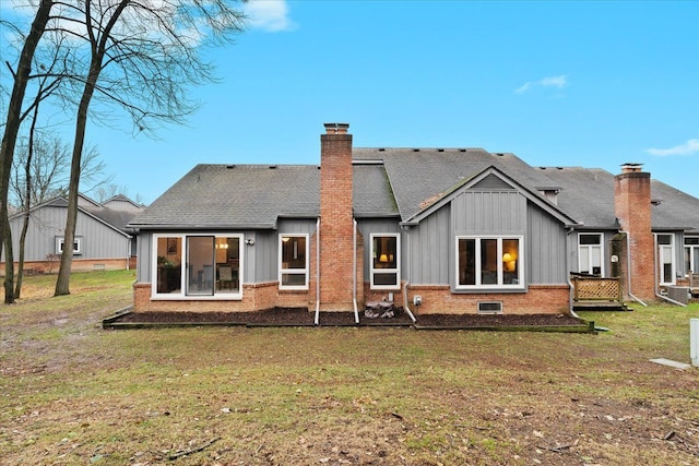 back of property featuring a lawn