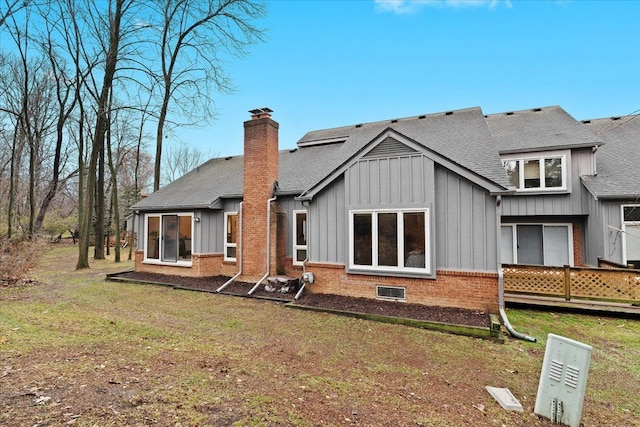 rear view of property featuring a lawn