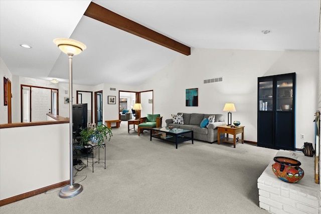 carpeted living room with lofted ceiling with beams