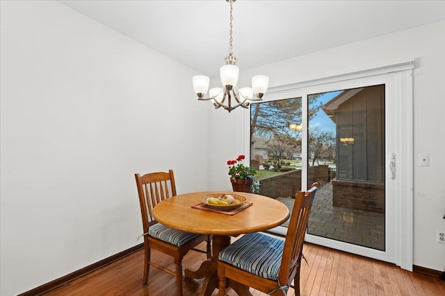 dining area featuring a chandelier and hardwood / wood-style flooring