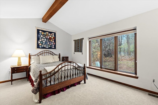 carpeted bedroom with vaulted ceiling with beams