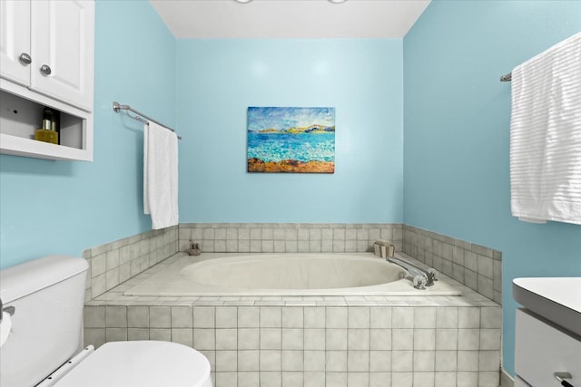 bathroom featuring a relaxing tiled tub, toilet, and vanity