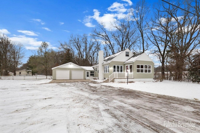 view of front of house featuring a garage and an outdoor structure