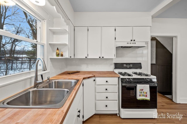 kitchen featuring white cabinets, white gas range oven, and wooden counters