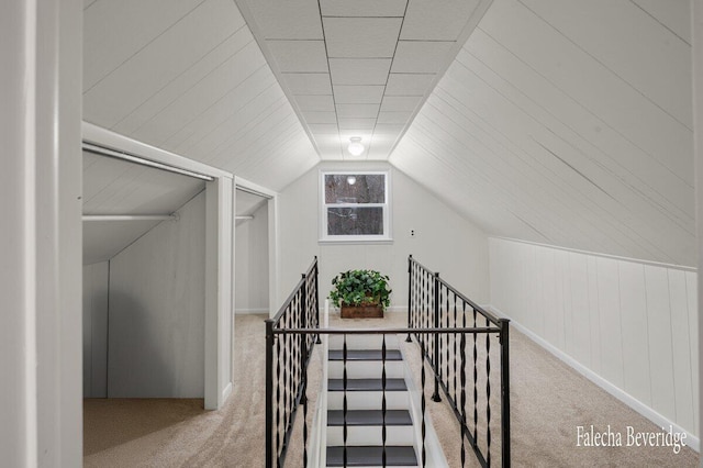 stairs with carpet flooring and vaulted ceiling