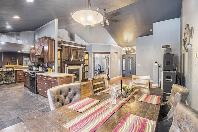 dining space with vaulted ceiling and ceiling fan