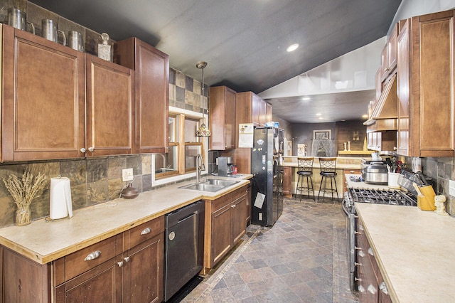 kitchen featuring sink, black dishwasher, stainless steel range with gas cooktop, refrigerator, and decorative light fixtures