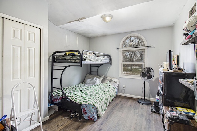 bedroom featuring hardwood / wood-style flooring and a closet