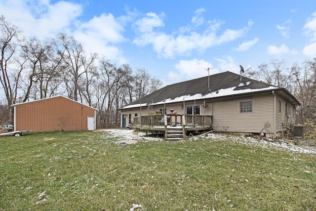 back of house with a lawn, central AC, an outdoor structure, a wooden deck, and a garage