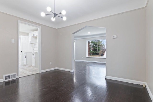 interior space featuring crown molding, dark hardwood / wood-style floors, and an inviting chandelier