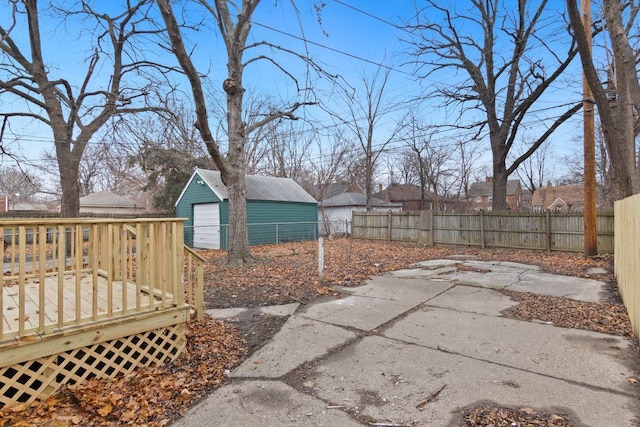 view of yard featuring an outbuilding, a garage, and a deck